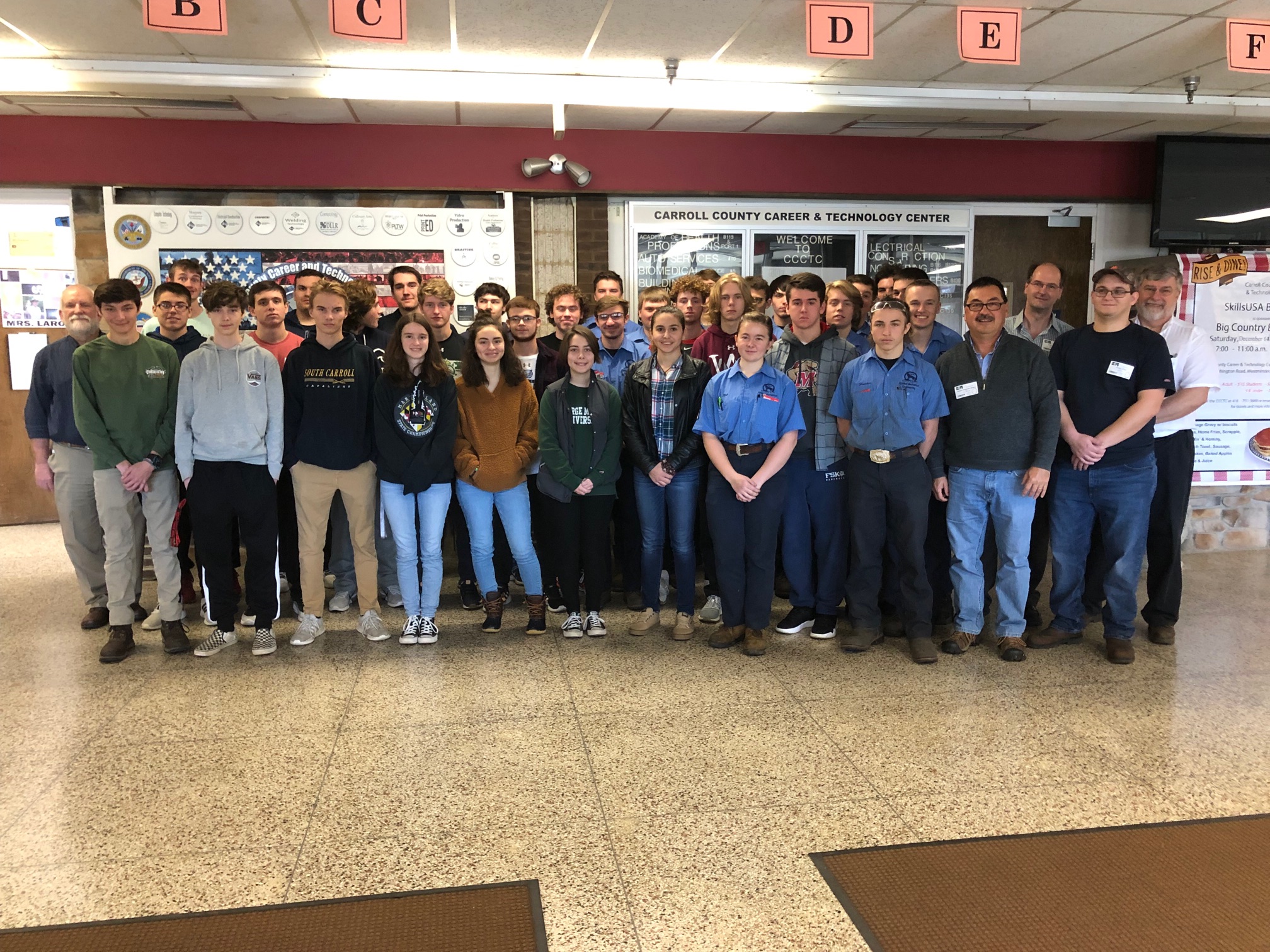 APL’s Hunter Turco (second from right), Erich Schulze (third from right) and Joseph Walters (fourth from right) join Tim Blizzard (far right) and his class at the Carroll County Career and Technology Center for a group photo.