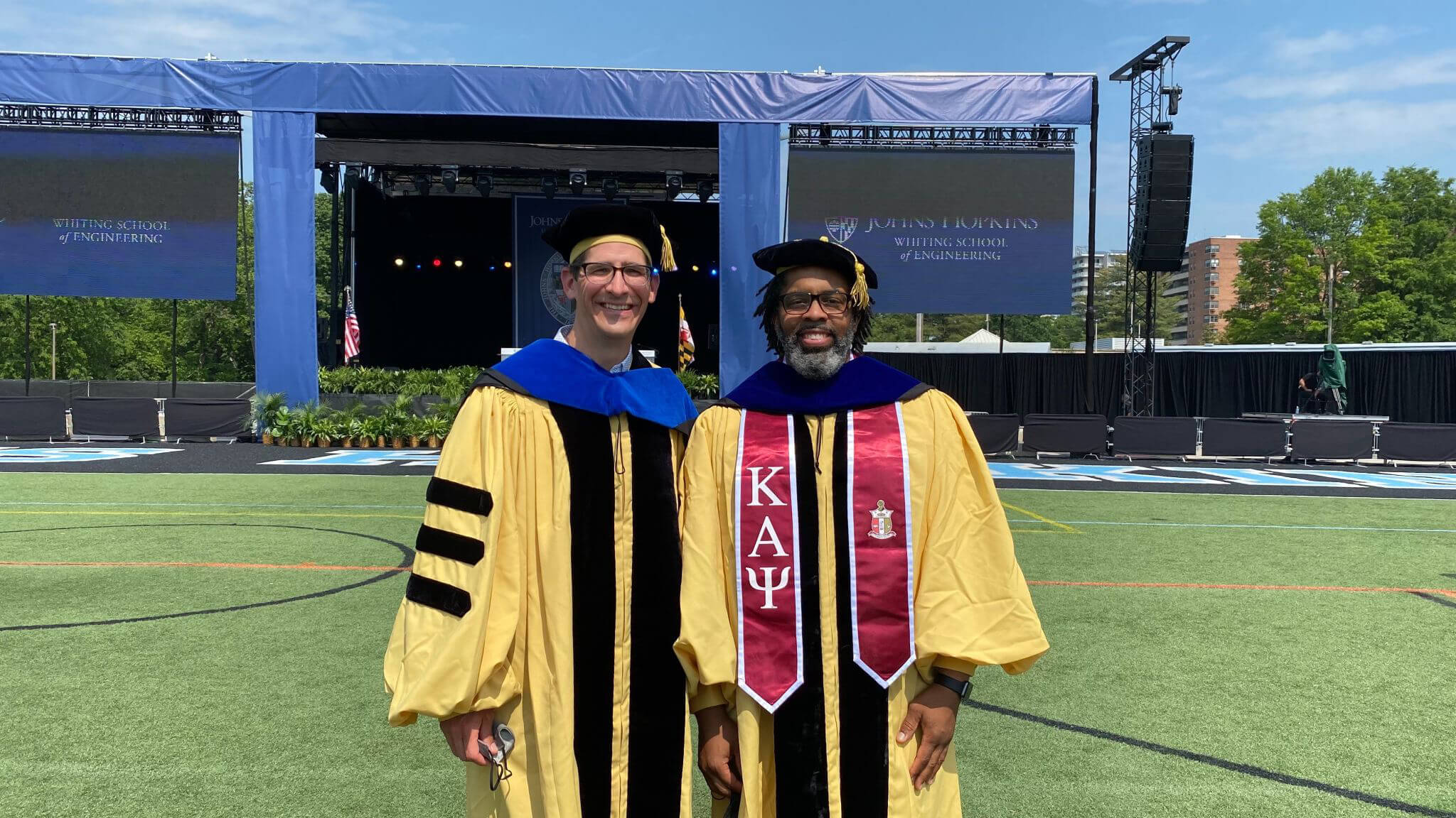 Bart Paulhamus (left) and Jeffrey Chavis pose for a photo after Johns Hopkins University’s doctoral program commencement ceremony.