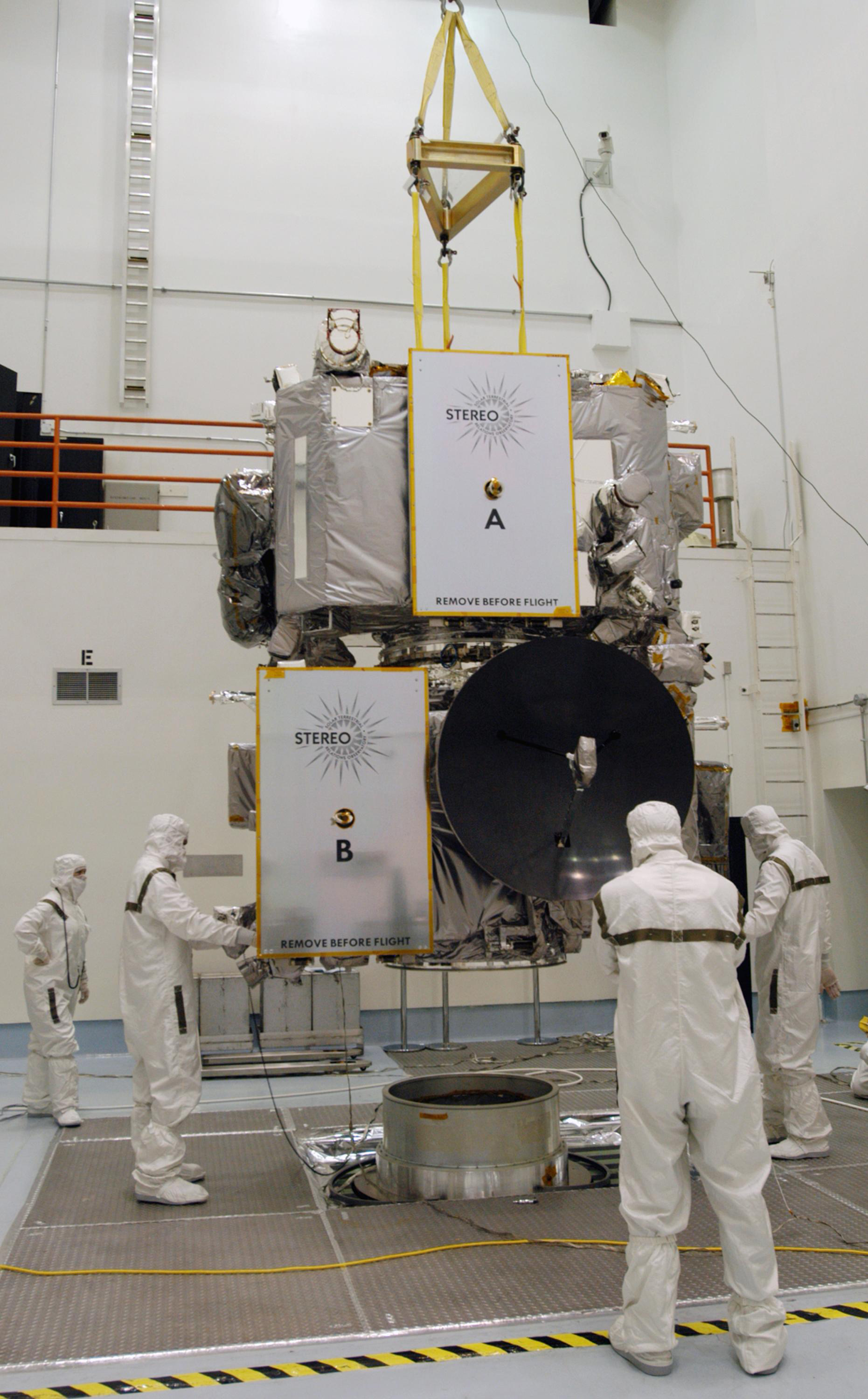 Technicians inside the Astrotech facility in Titusville, Florida, move the STEREO spacecraft to the spin table
