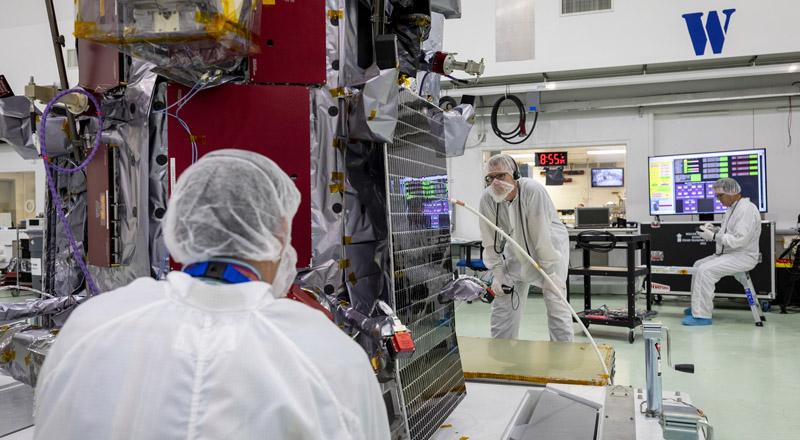 Members of the Parker Solar Probe team examine and align one of the two solar arrays