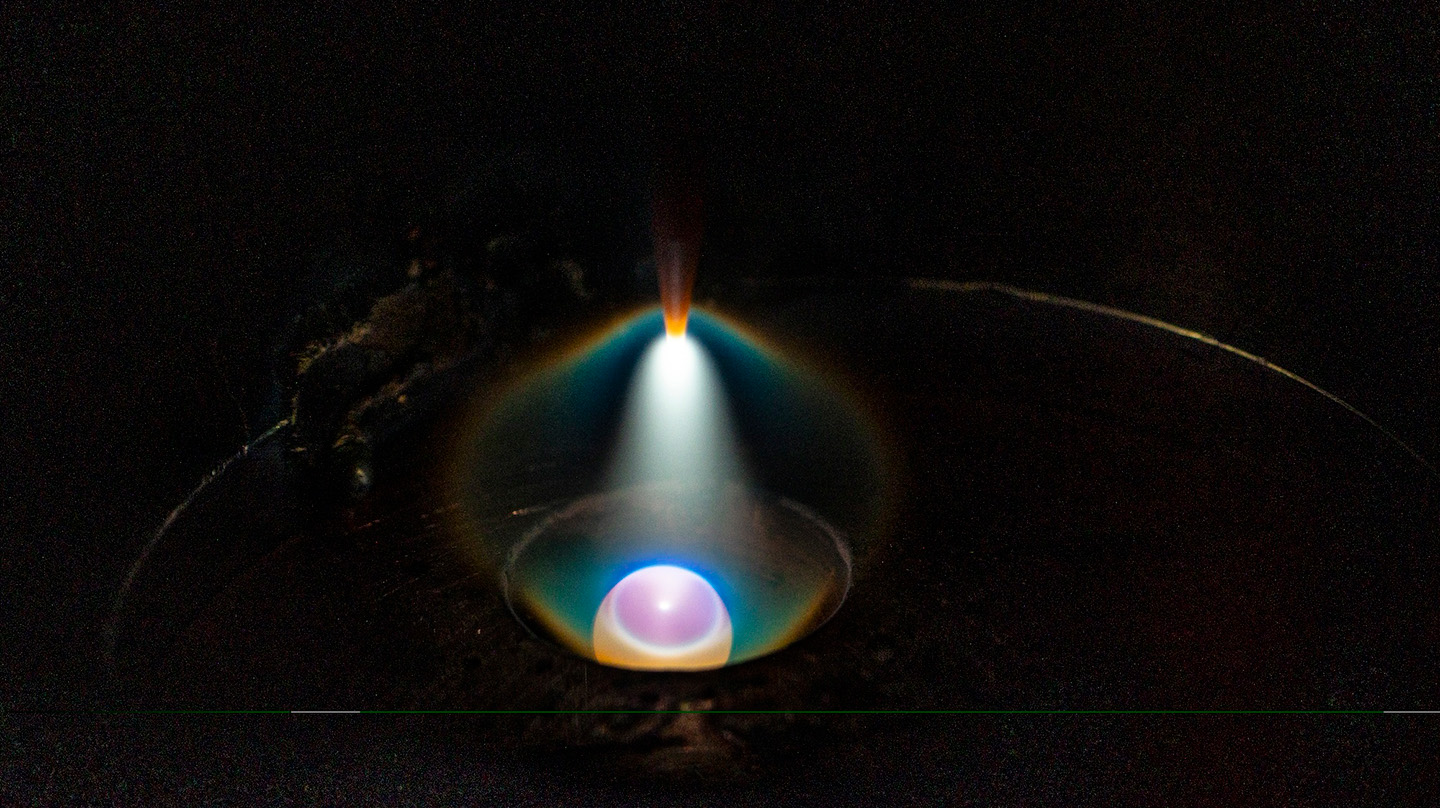 A view inside the arc melter shows how the high heat generates an arc to quickly melt multi-principal element alloys.