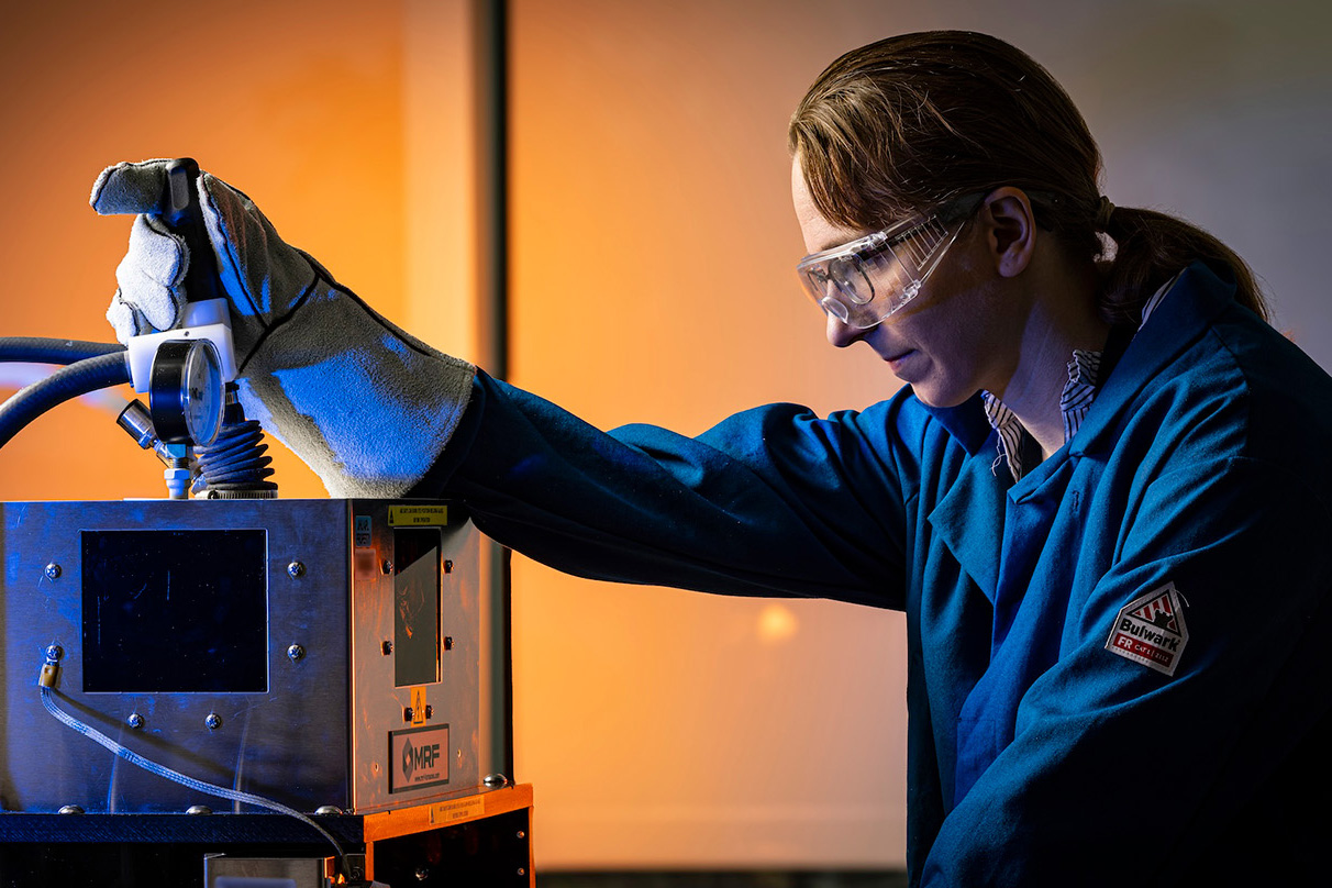 An APL materials scientist works with an arc melter