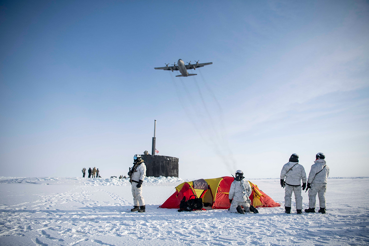 A C-130 Hercules assigned to the 109th Airlift Wing, New York Air National Guard, flies over East Coast-based Naval Special Warfare Operator (SEALs), Norwegian Naval Special Operations commandos and the Los Angeles-class attack submarine USS Hampton (SSN 767) during an integration exercise to bolster skills in an Arctic environment March 9, 2024, as part of Arctic Edge 24. Credit: U.S. Air National Guard/Chief Petty Officer Jeff Atherton