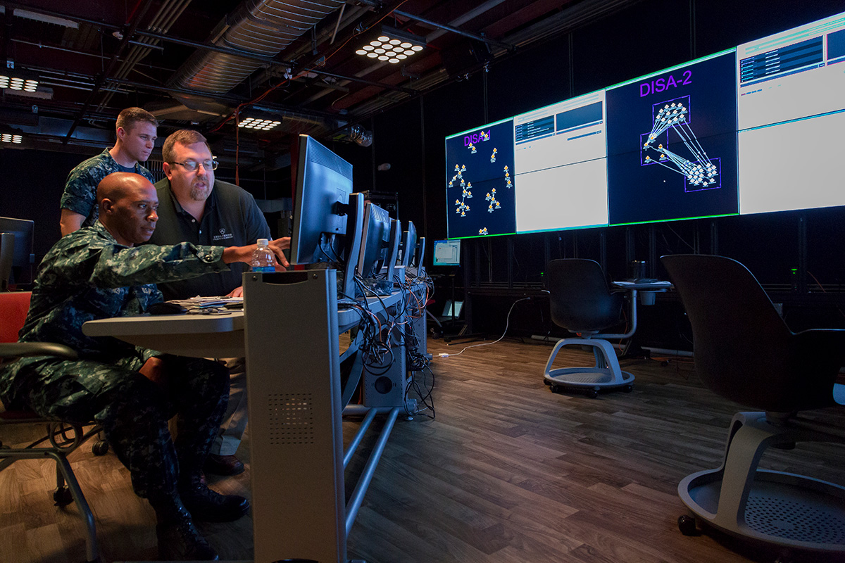 Two military service members look at data in Johns Hopkins APL's LIVE Lab