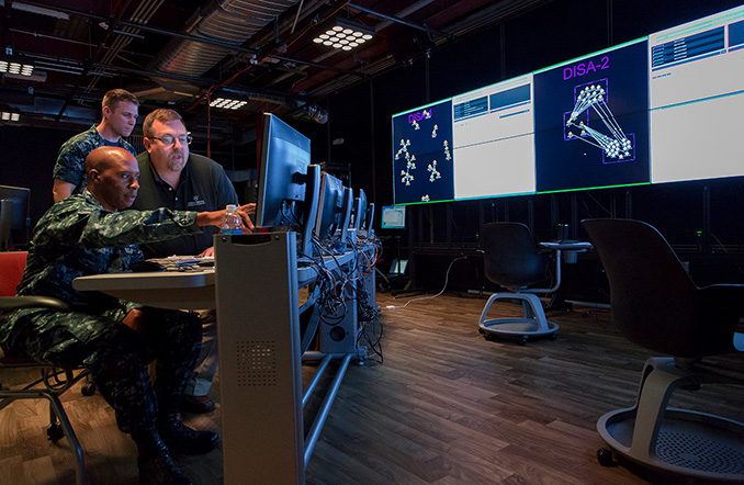 Two military service members look at data in Johns Hopkins APL's LIVE Lab