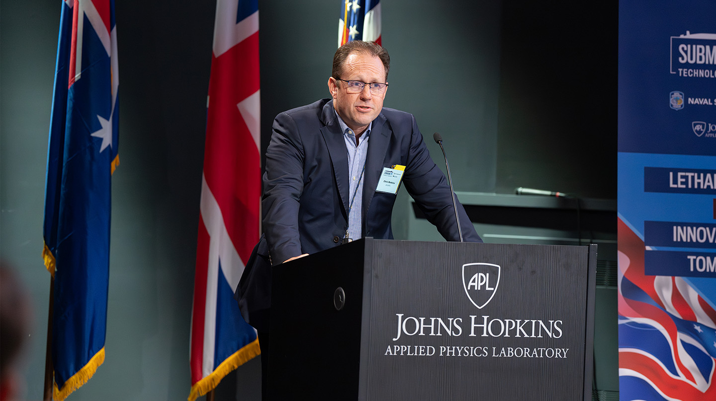 Chris Watkins, co-chair of the Submarine Technology Symposium and Sea Control mission area executive at APL, offers his opening remarks to the symposium.
